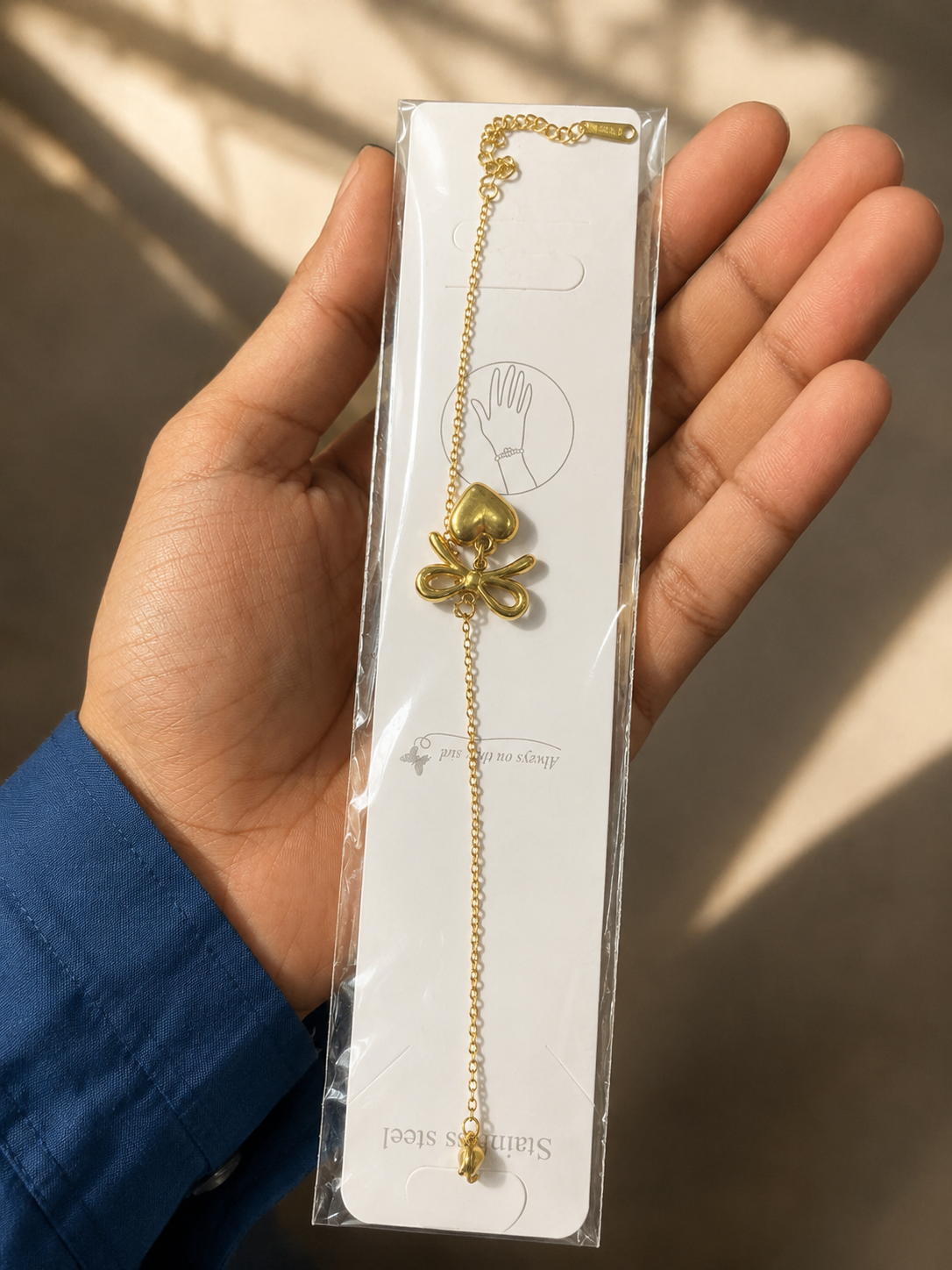 Zinmeerjewells gold bow bracelet and heart bracelet packaged cleanly, highlighting premium stainless steel anti tarnish jewelry Pakistan.